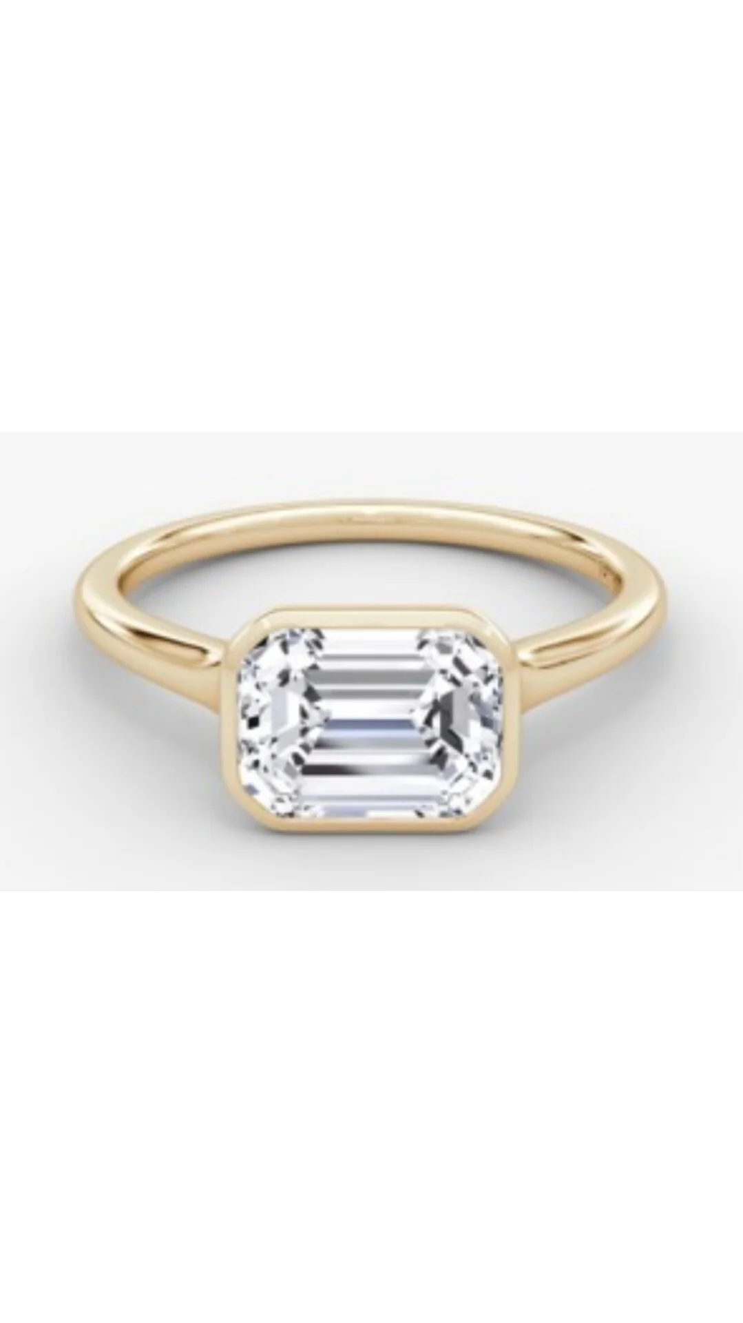 East-west bezel set emerald cut lab-grown diamond ring in yellow and white gold